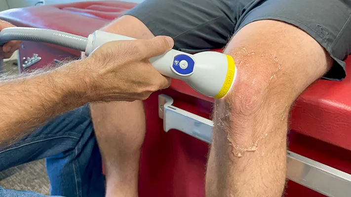 Softwave therapy on a patient's knee